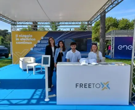 Free To X booth and 4 Free To X staff members