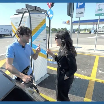 Andrea and Valentina talking near a Free To X column.