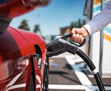 Detail of a person charging an electric car